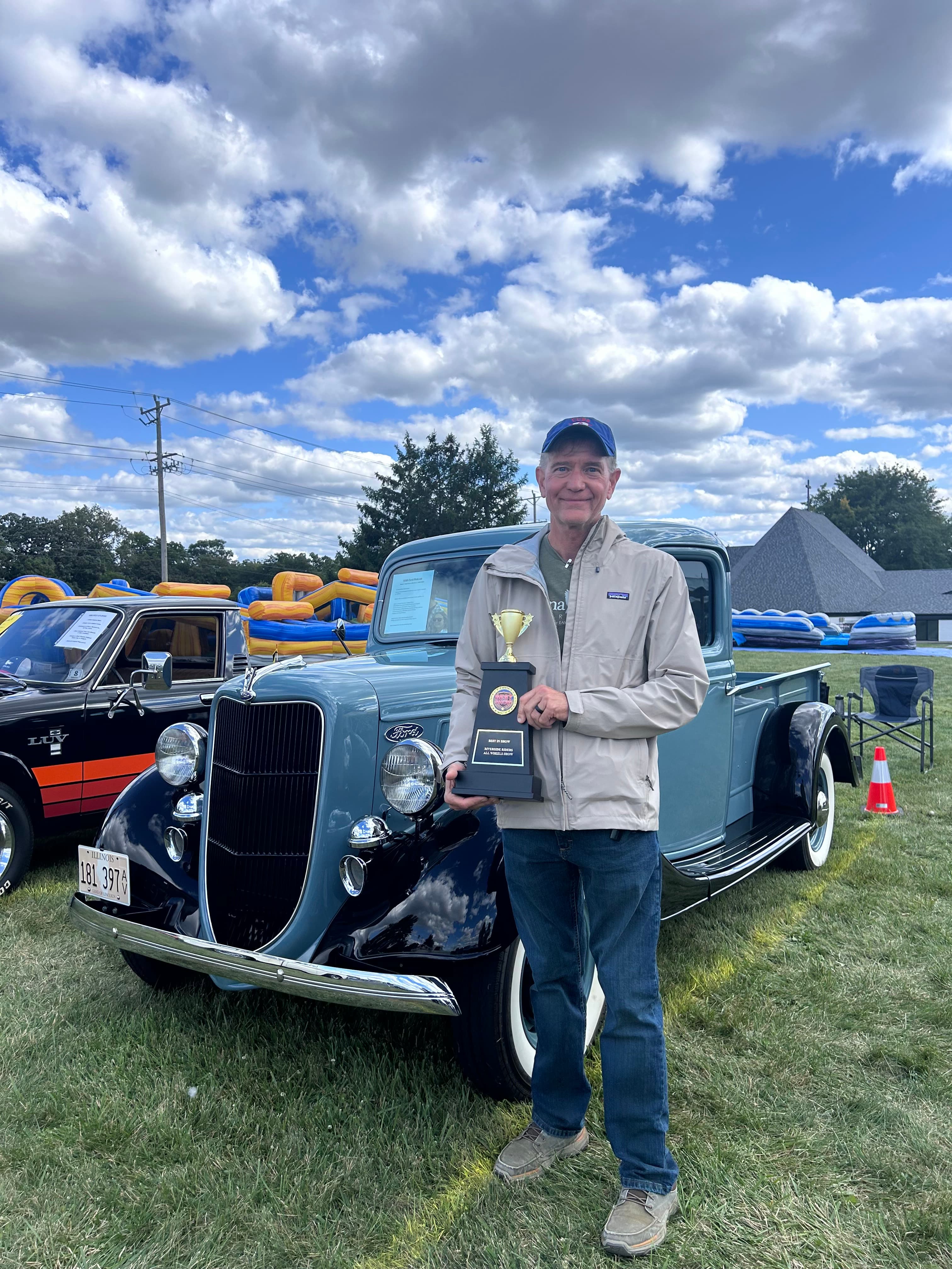 Attendees and families enjoying the free car show with trophies and live music at Riverside Community Church